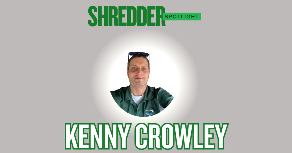 Photograph featuring a man named Kenny Crowley. The top of the image reads "SHREDDER SPOTLIGHT" in green text. Below, a circular photo shows Kenny Crowley, a man with short dark hair and light stubble, wearing sunglasses on his head and a dark green polo shirt over a white t-shirt, looking directly at the camera. At the bottom, his name "KENNY CROWLEY" is written in large green outline letters with white fill.